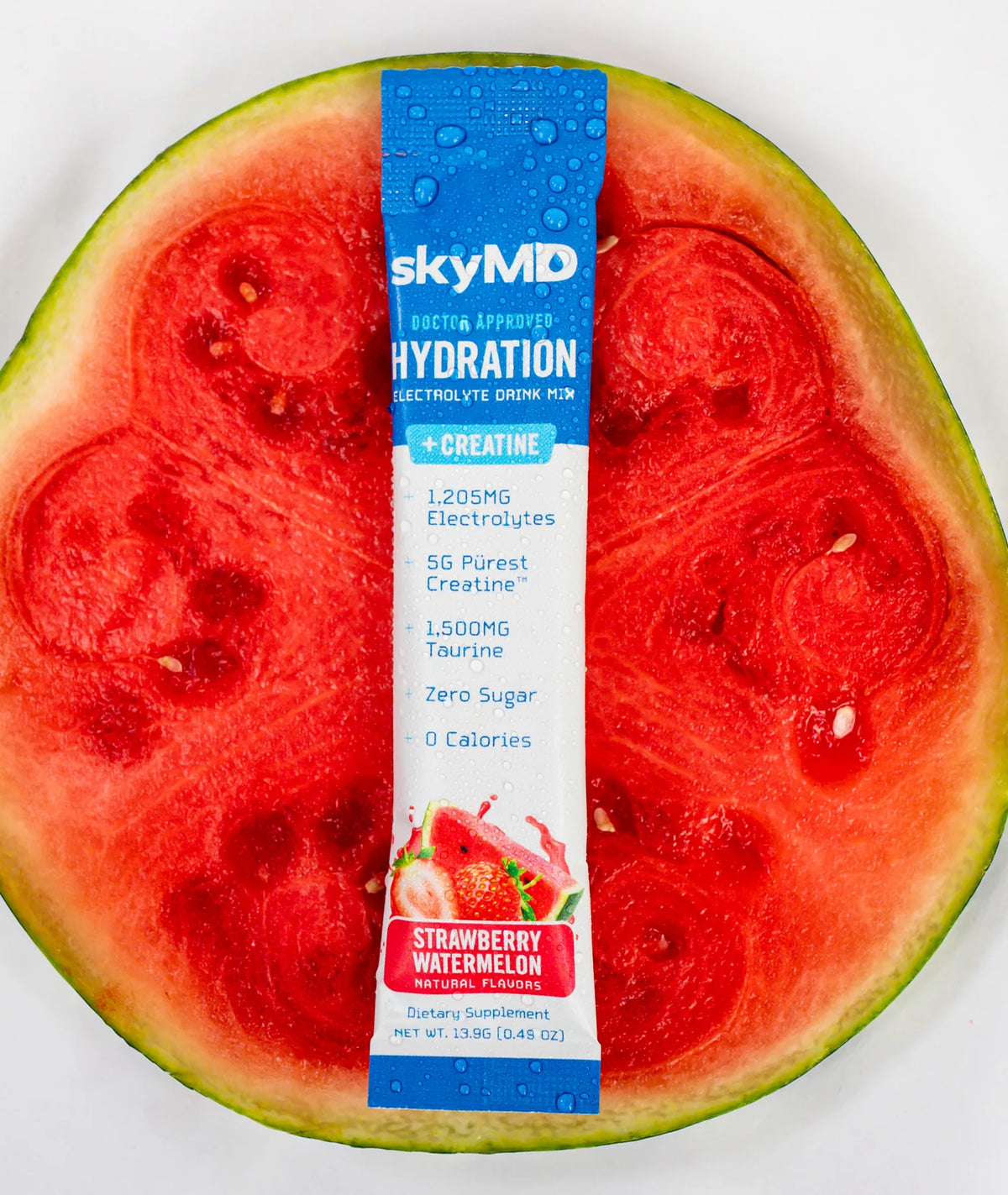 A SkyMD Hydration + Creatine stick pack resting on a slice of watermelon